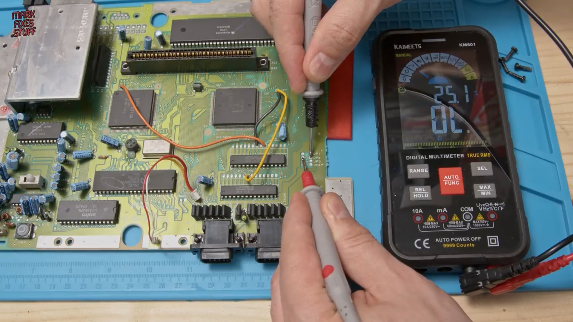 Mark Fixes Stuff testing continuity with a multimeter on a Sega Megadrive during a region mod