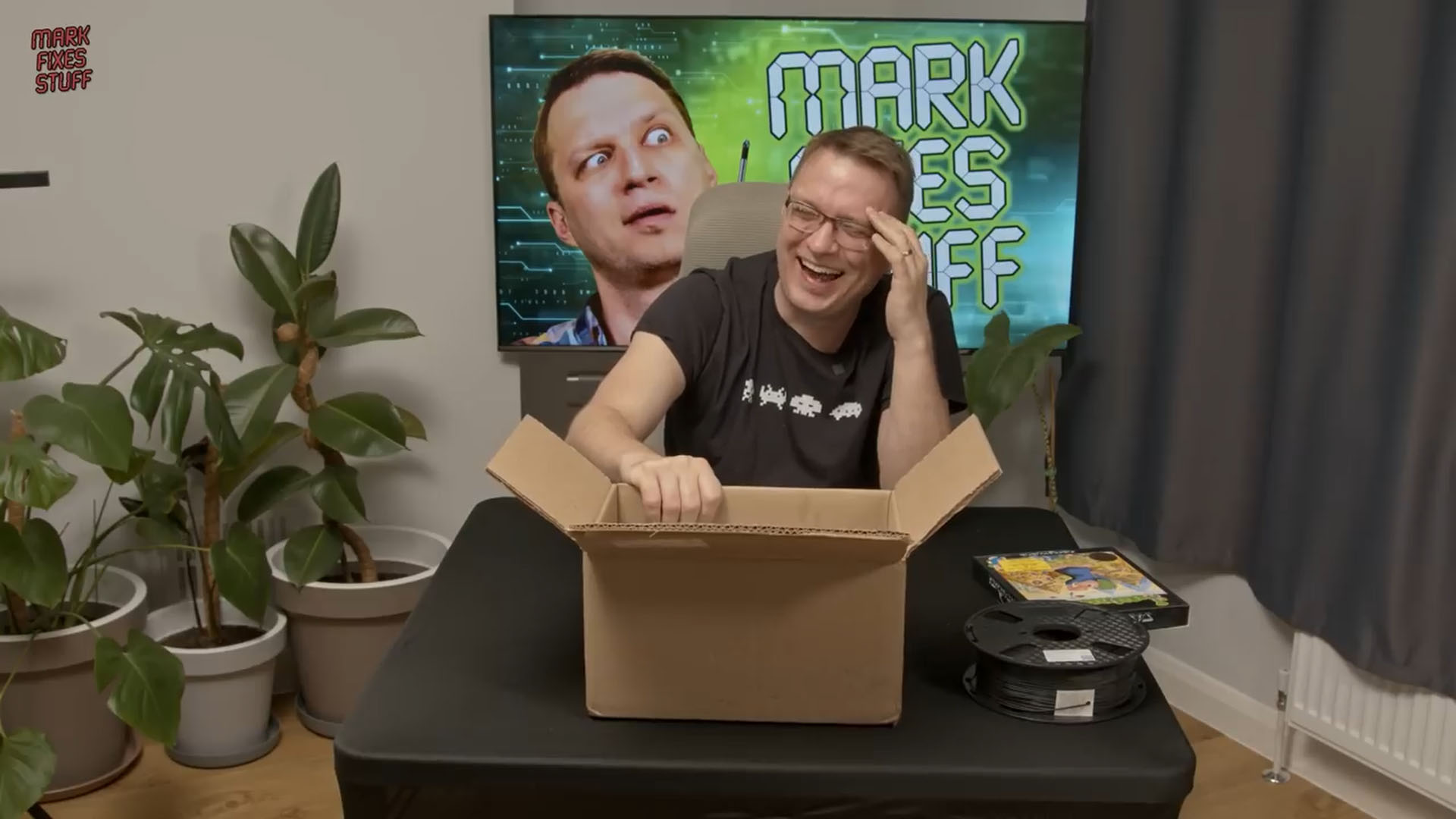 Mark from Mark Fixes Stuff laughing at a package from Lemmings Creator Mike Dailly