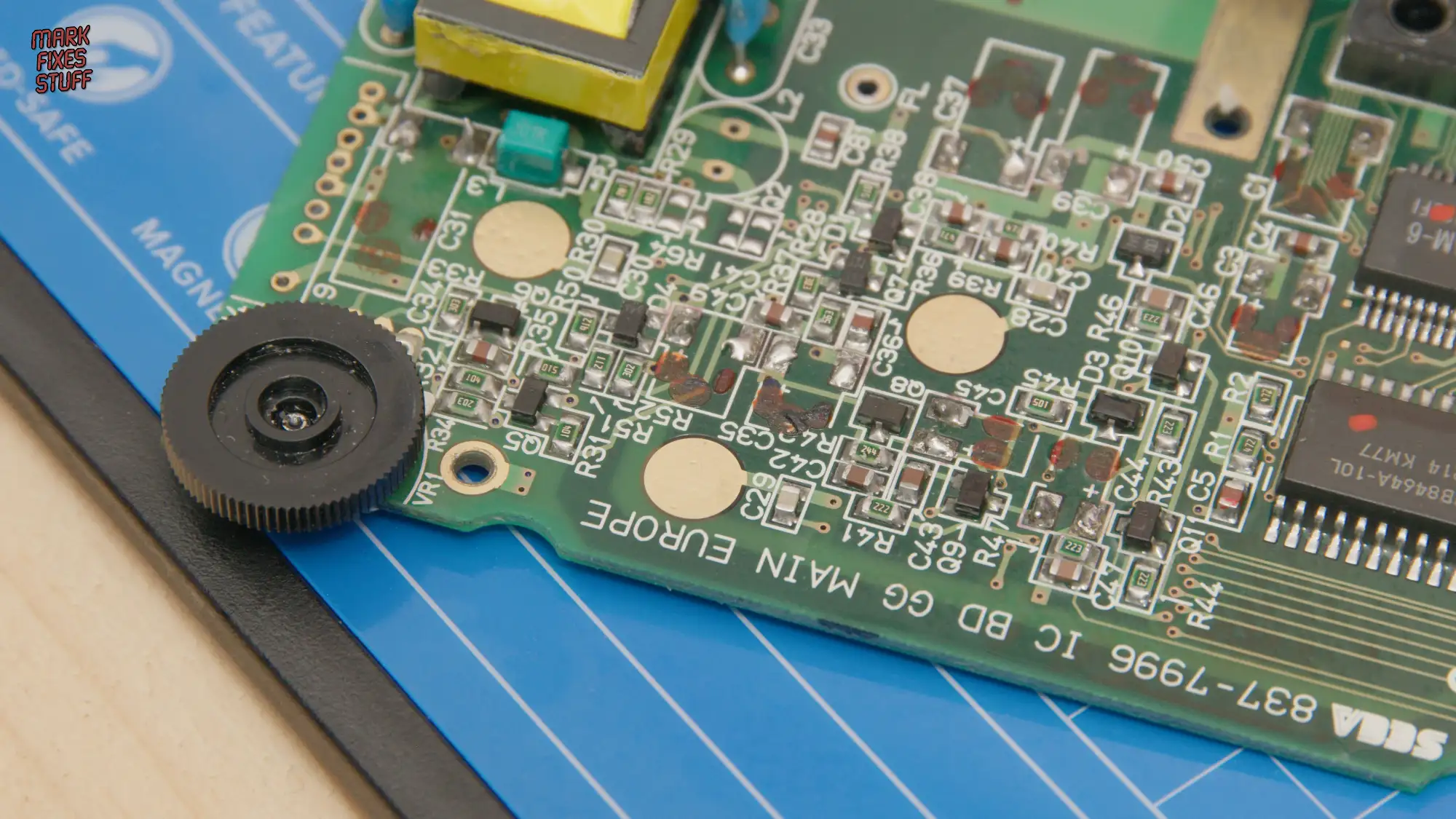 Sega Game Gear PCB with corrosion and leaked capacitor damage close up