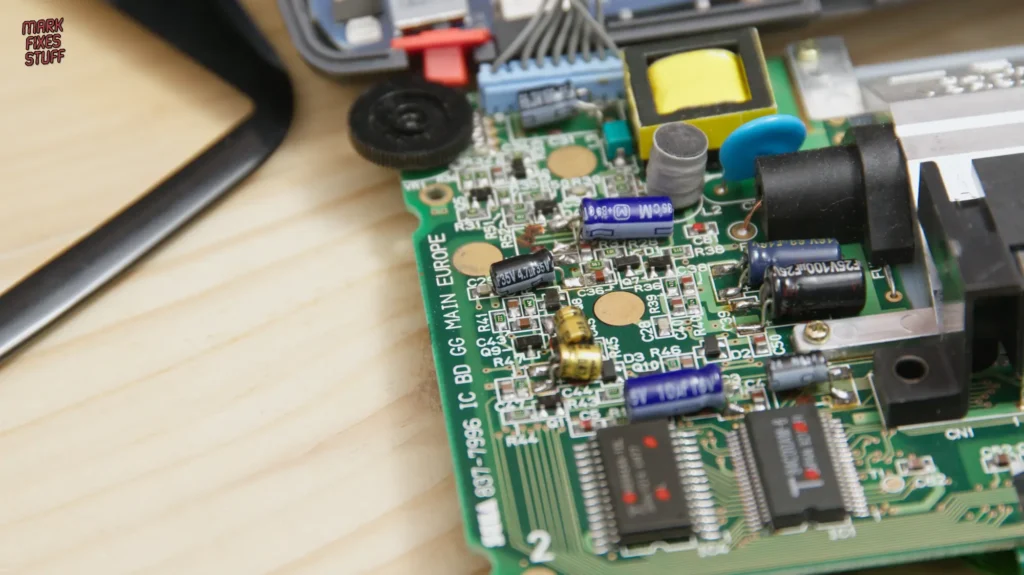 Sega Game Gear motherboard with replaced capacitors and soldering work visible