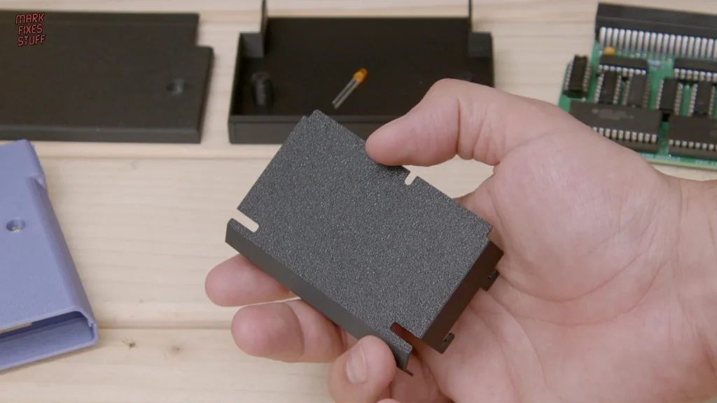 Thin 3D printed replacement cable cover for a Sharp Twin Famicom, printed in PLA.