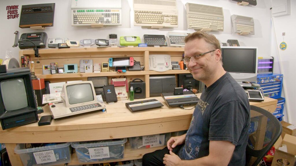 Mark seated at his retro gaming workbench with Atari 2600 Junior and Atari 7800 consoles