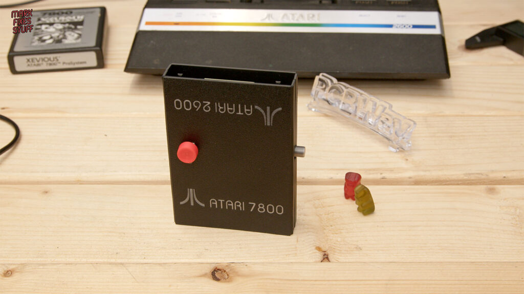 Black Pico A10400 cartridge case with Atari 2600 and 7800 labels, a red power button and silver reset extension