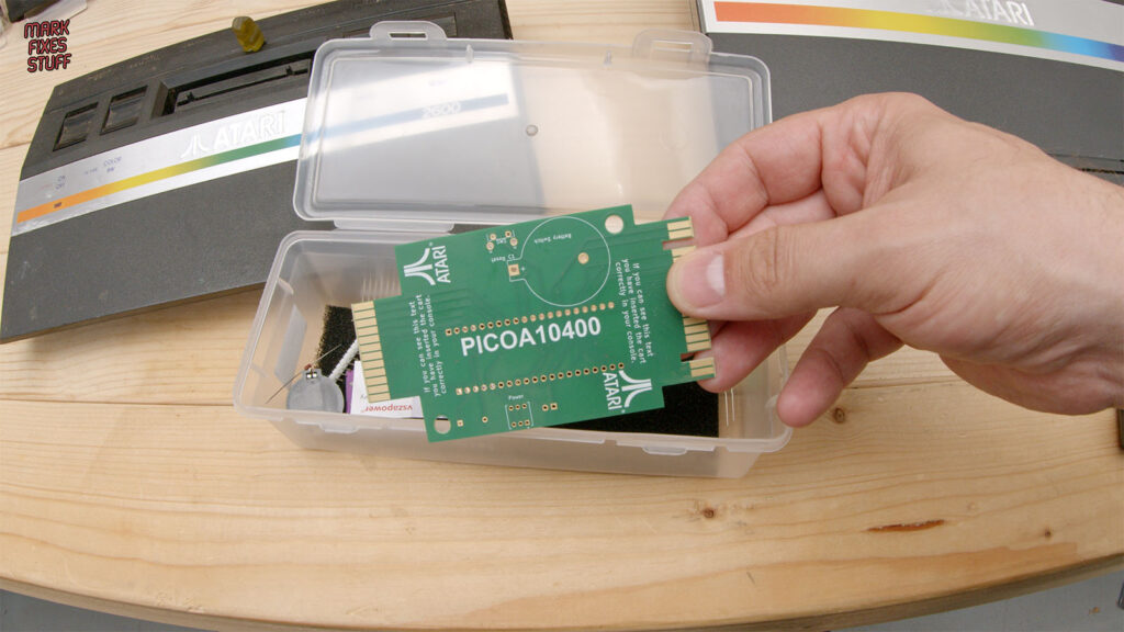 Mark holding an unpopulated Pico A10400 circuit board with cartridge connectors at opposite ends